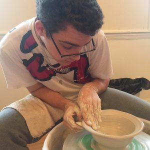 Abe throwing on the wheel